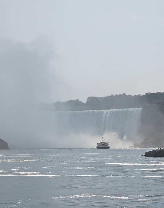 Boat appearing from mist of Niagra Falls