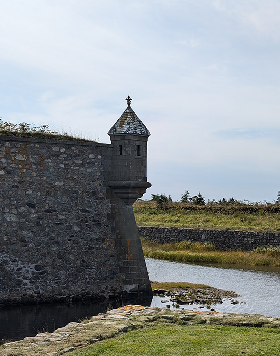 old brick wall with turret on corner